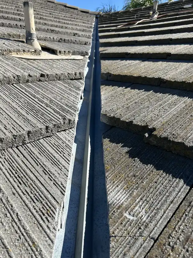Roofer performing preventative roof maintenance