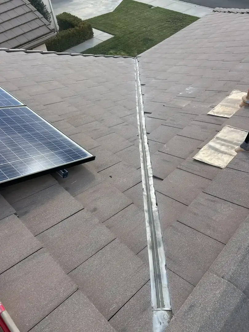 Roofer tracing a roof leak to its source