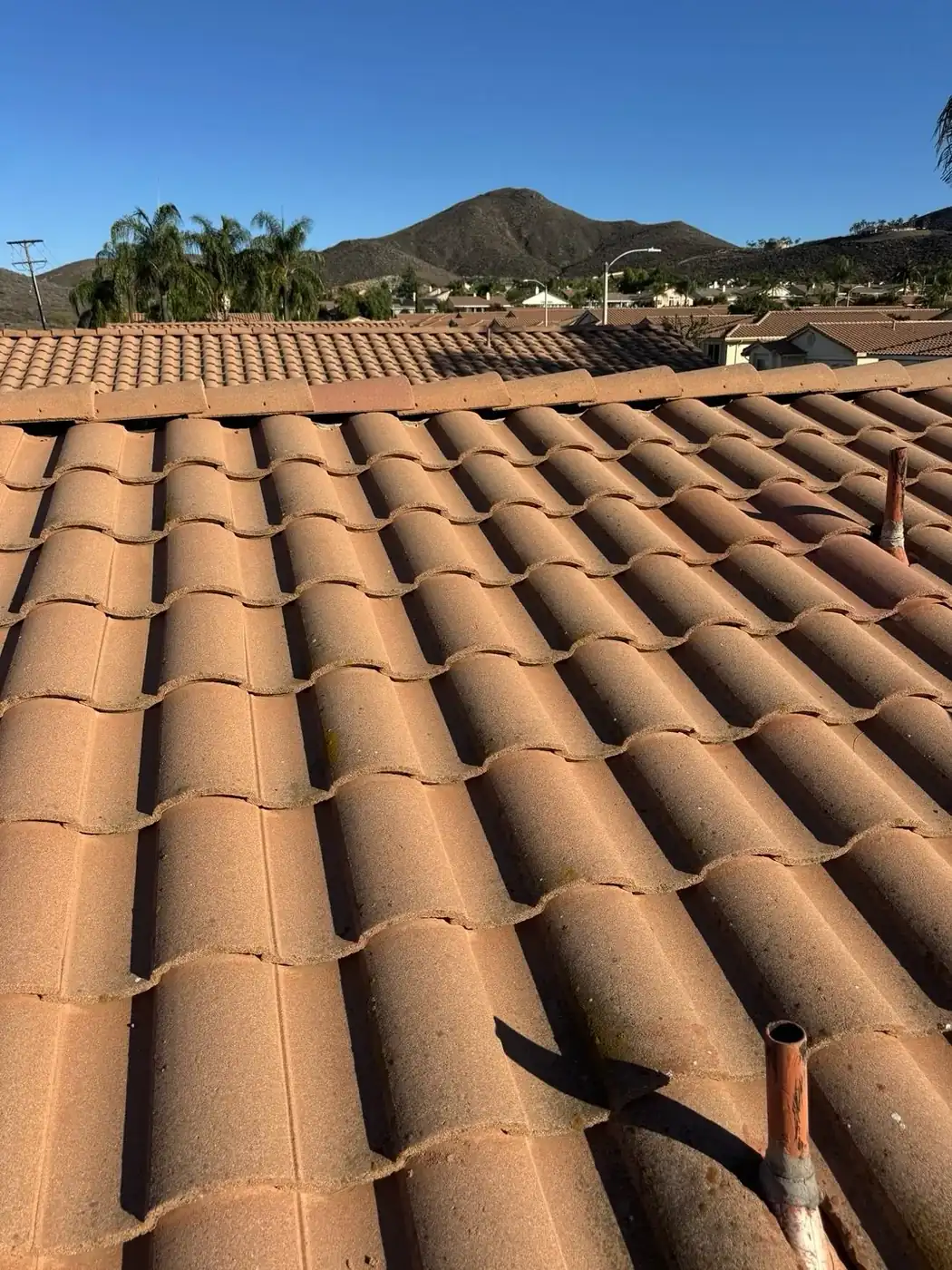 Tile roof repair in progress on a residential tile roof